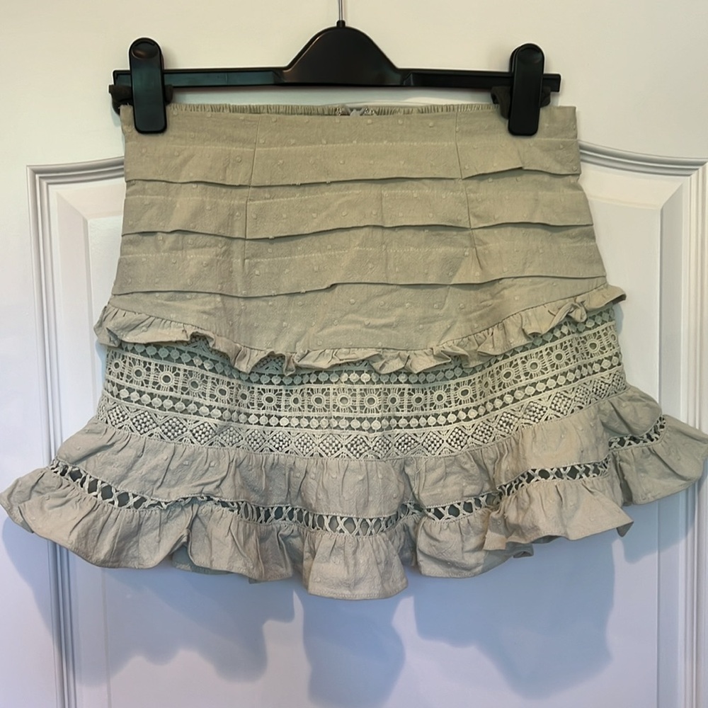 This is a mini green skirt.